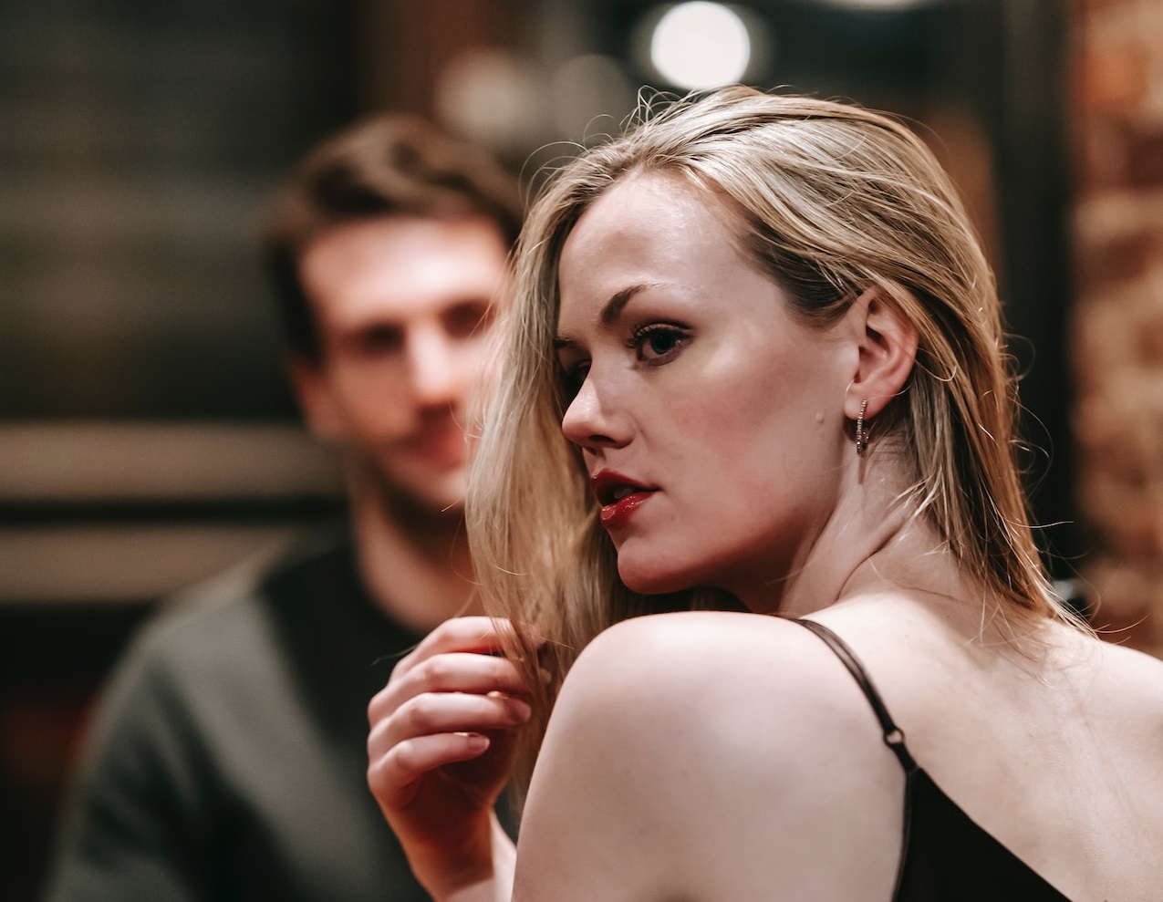 Woman is looking around at restaurant.