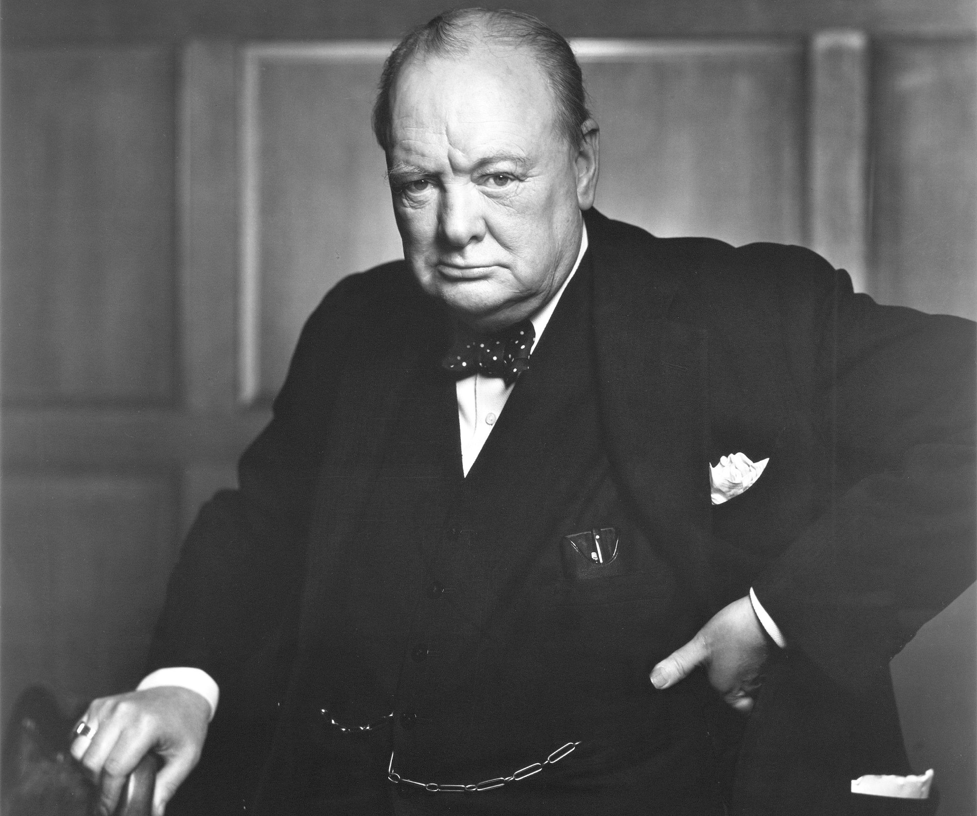 Winston Churchill in suit by a chair