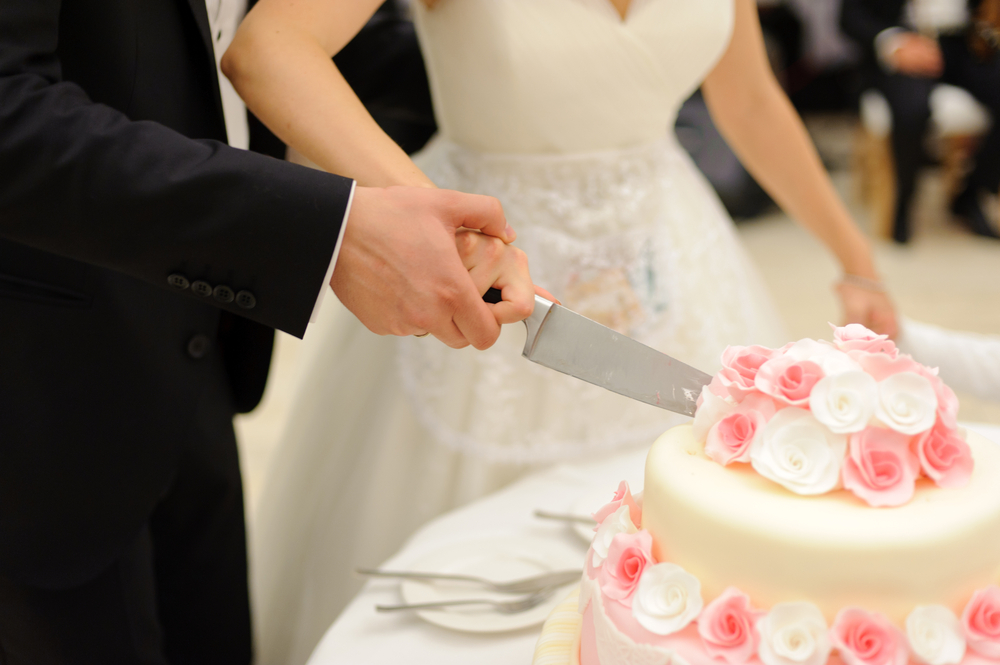 bride and groom cutting beautiful wedding cake