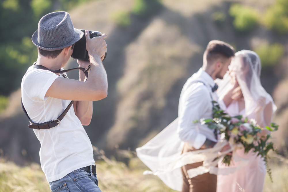 A wedding photographer takes pictures