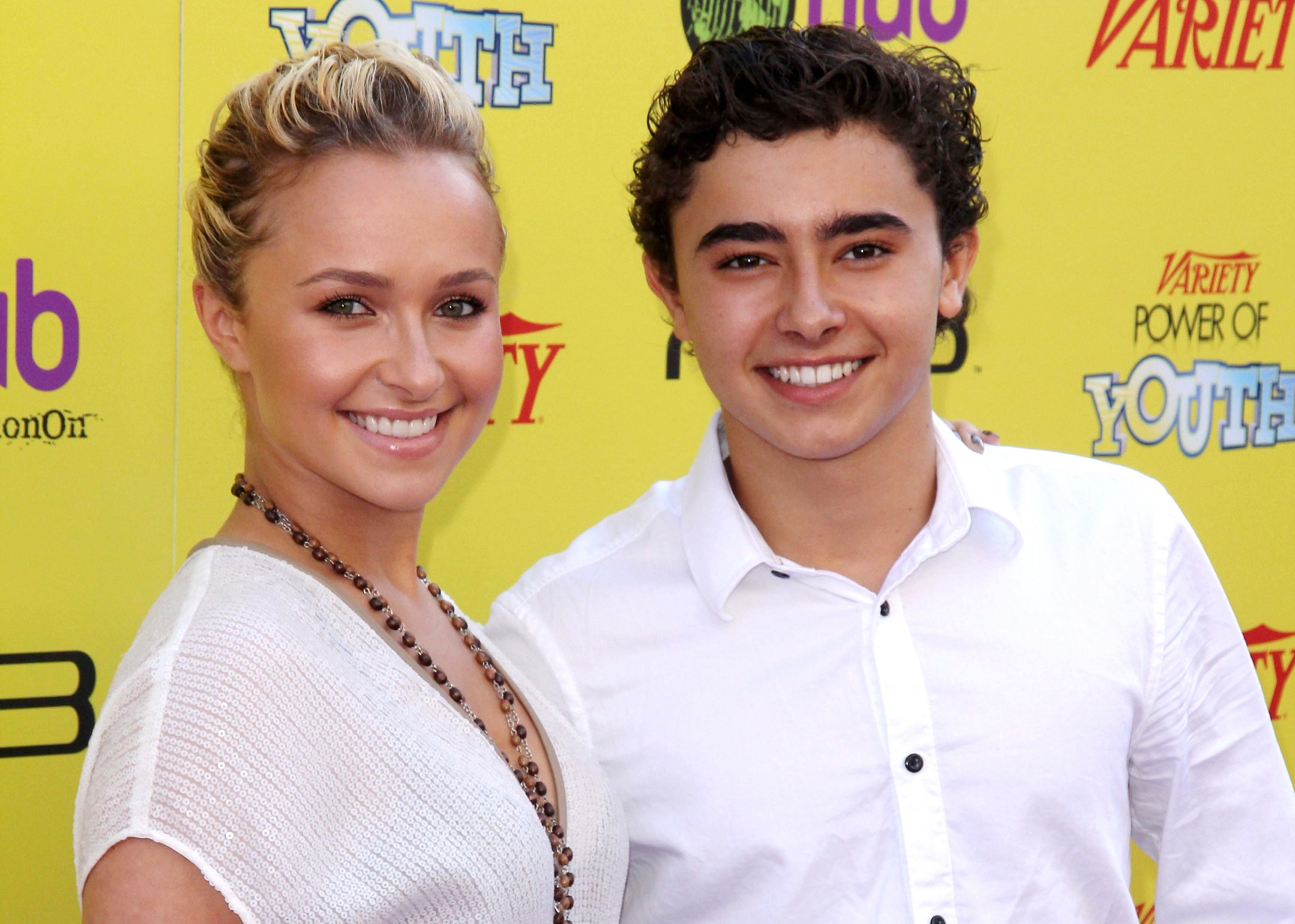 Hayden Panettiere and brother Jansen Panettiere wearing white shirts and smiling on the yellow background - 2011