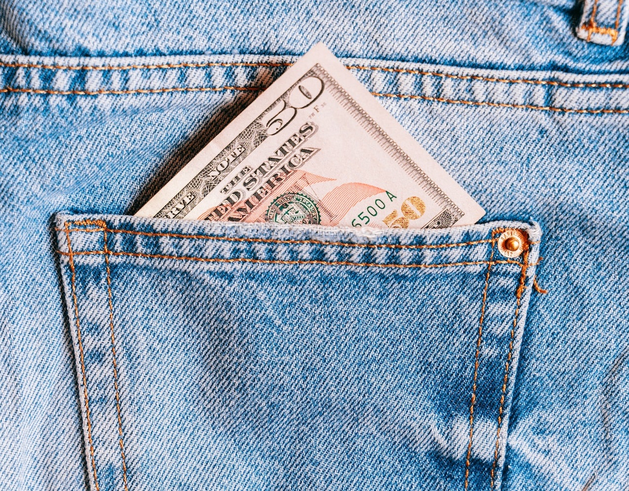 50 dollar bill inside a blue jeans back pocket.