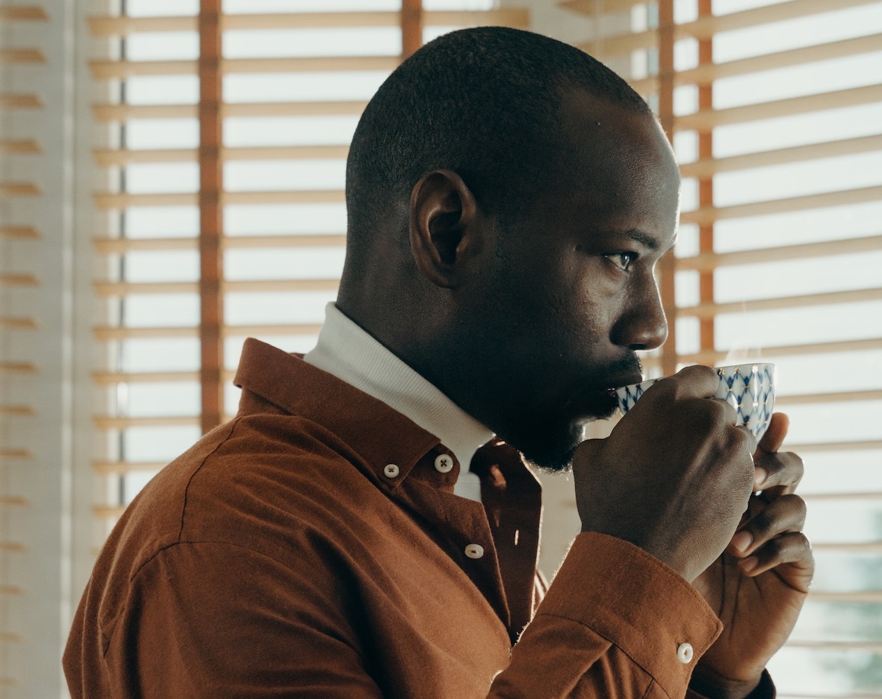 Black man drinking coffee