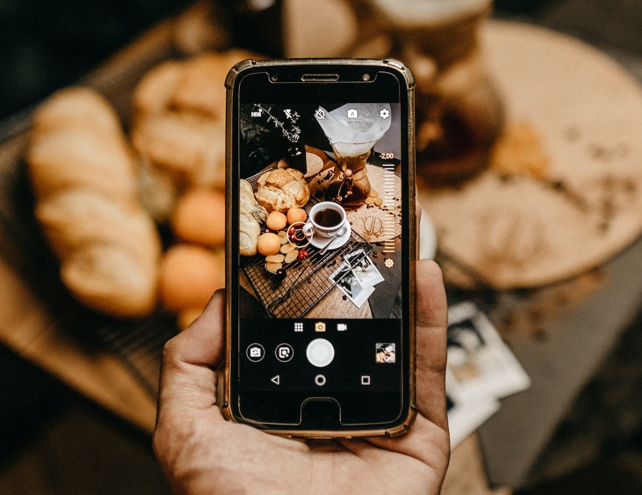 Man holding his phone and filming his breakfast at morning.