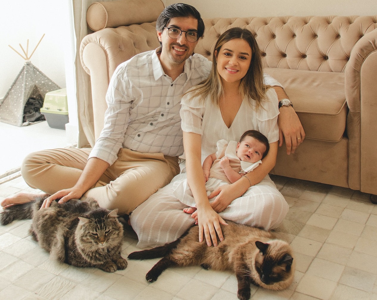 Couple with their baby and two cats.