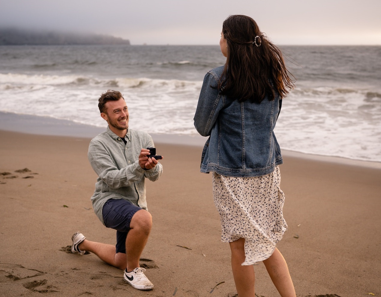 Man proposing to a woman on the beach.