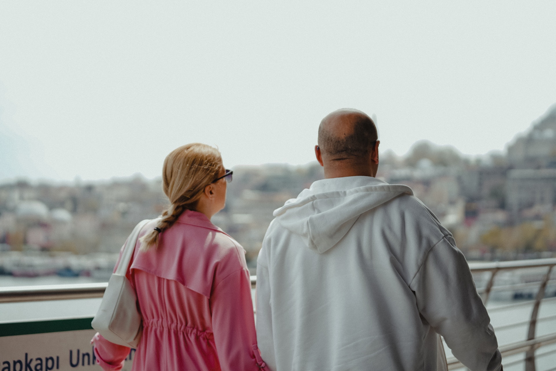Back view of couple walking together outside