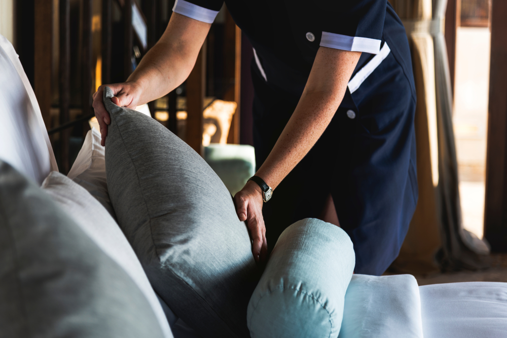 Half view of a Housekeeper cleaning a hotel room