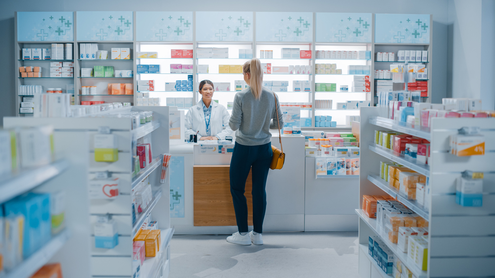 Female Cashier in White Coat at pharmacy