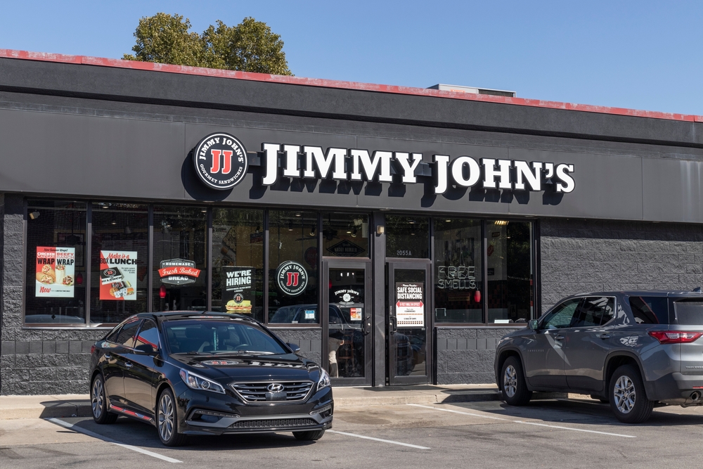 Jimmy John's restaurant building with two cars in front