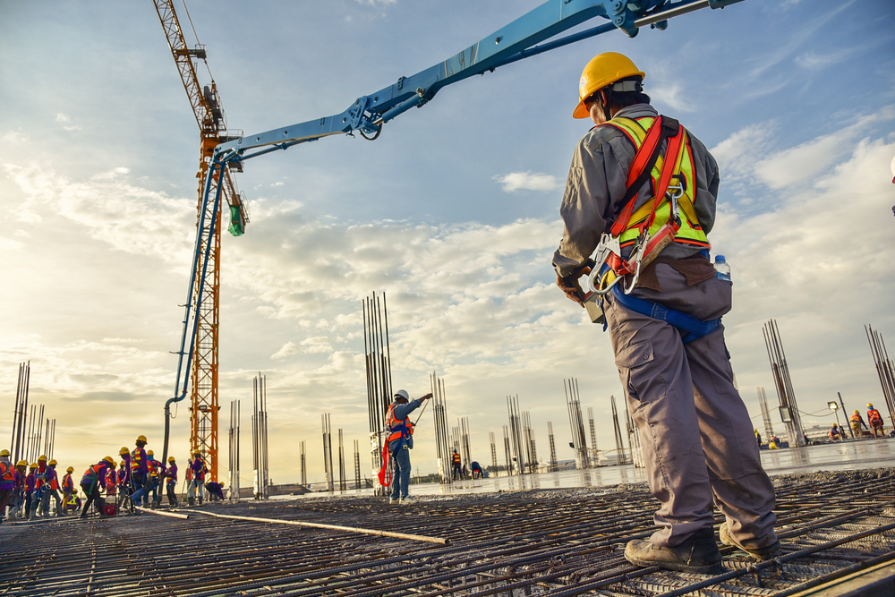 A construction worker wearing harness working on construction site