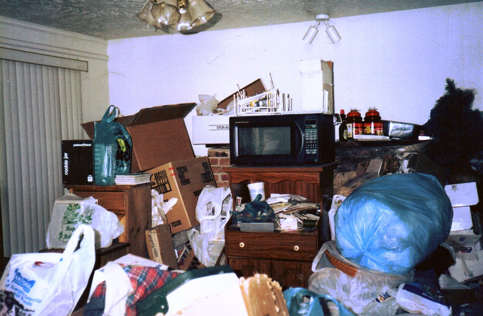 Hoarding living room full with piles of junk and stuff.