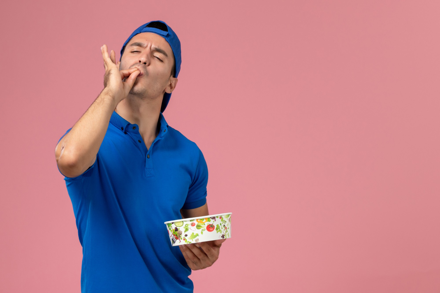 Man holding a plate and makes tasty sign.