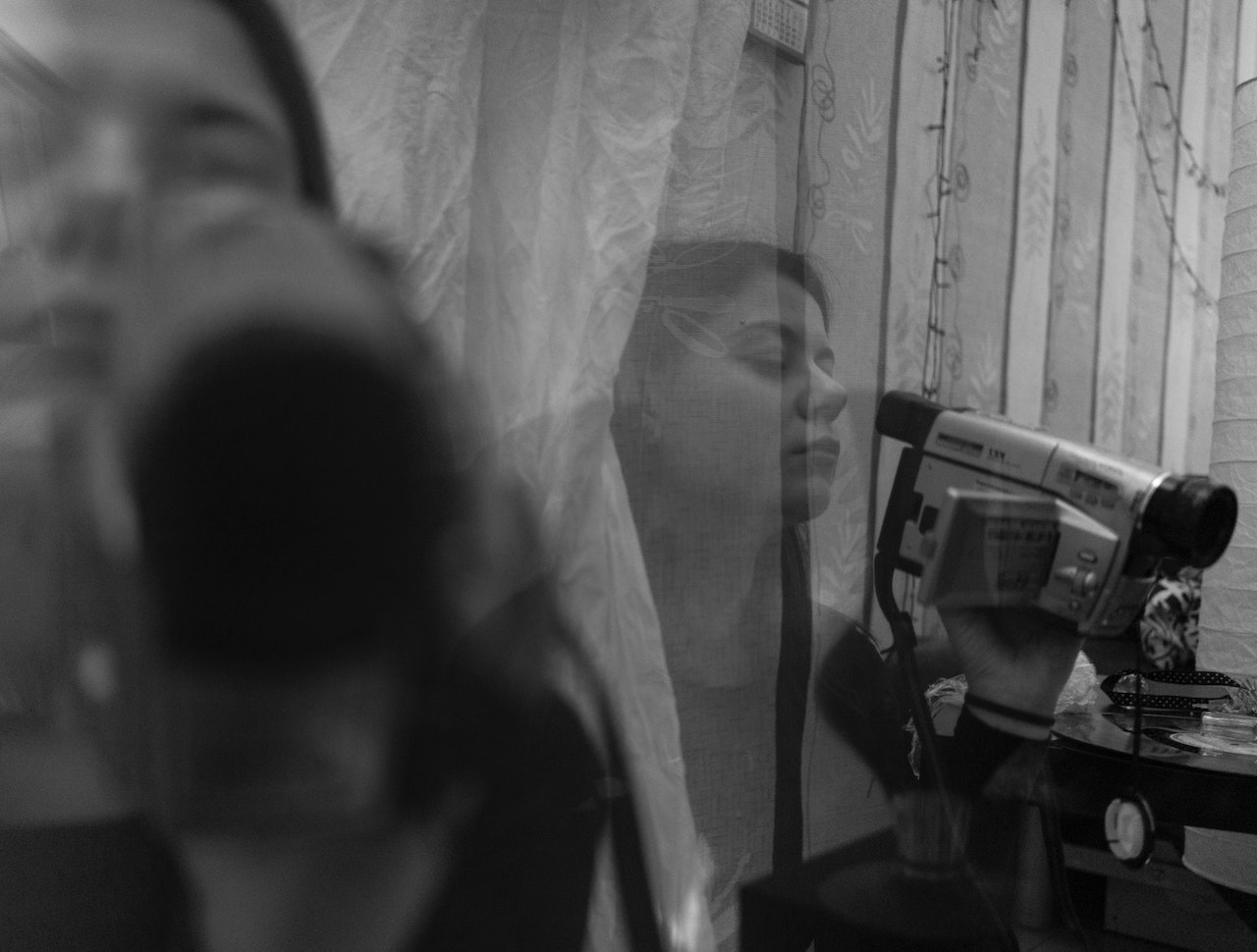 Woman filming a video with a camera.