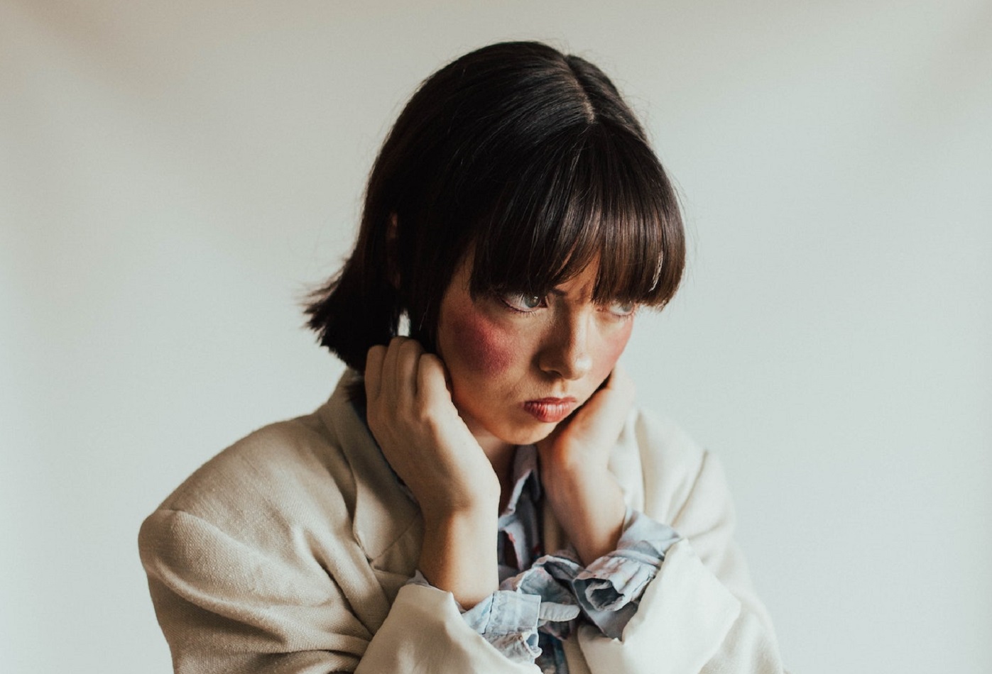 Upset woman with mad face wearing white coat.