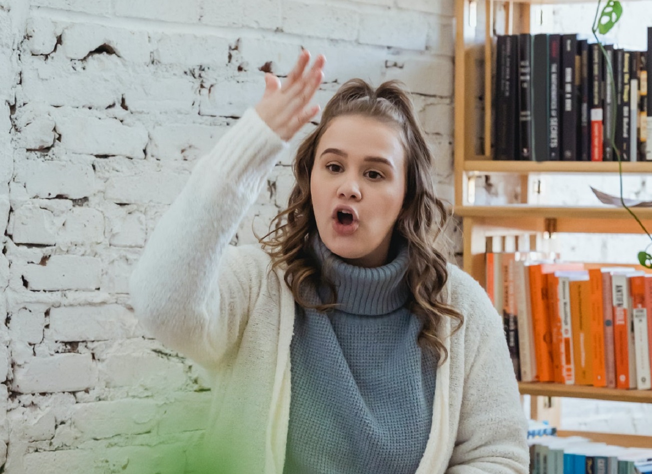 Young woman yelling and pointing.