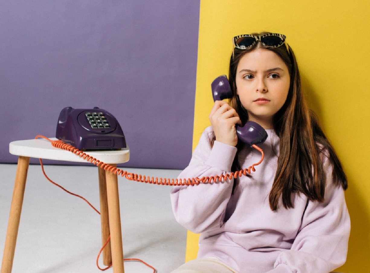 Small girl talking on the telephone,