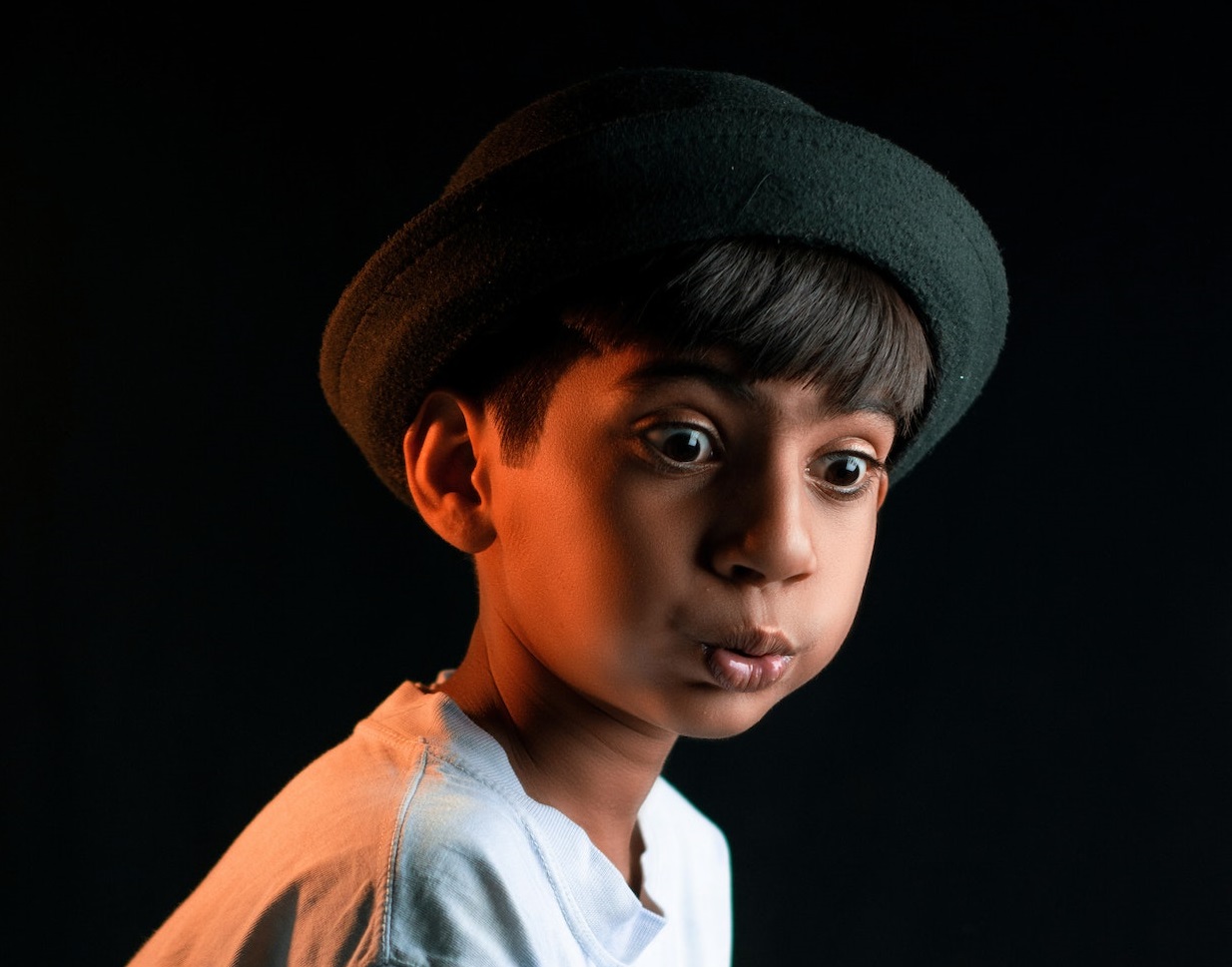 Young kid having surprised face looking a side.