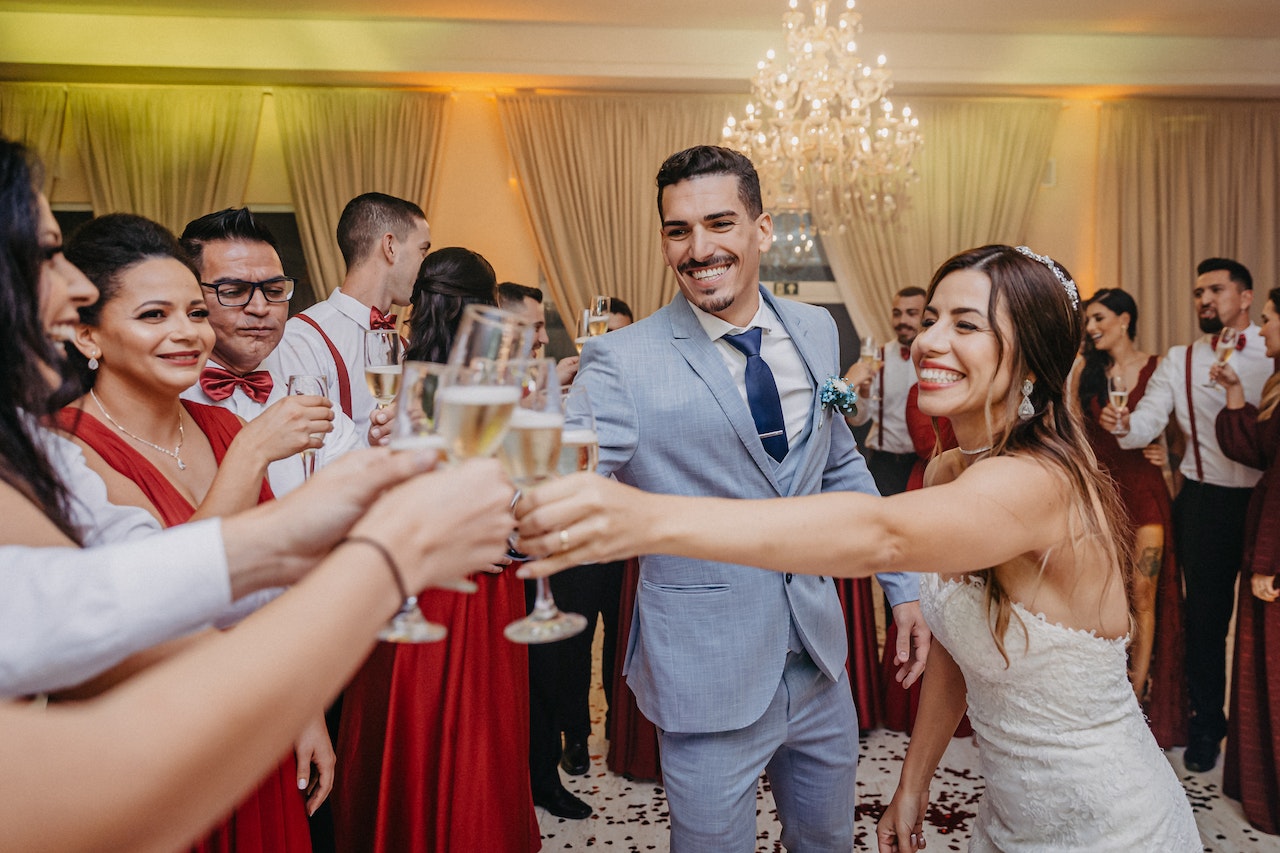 People at wedding making a wedding toast with bride and groom.