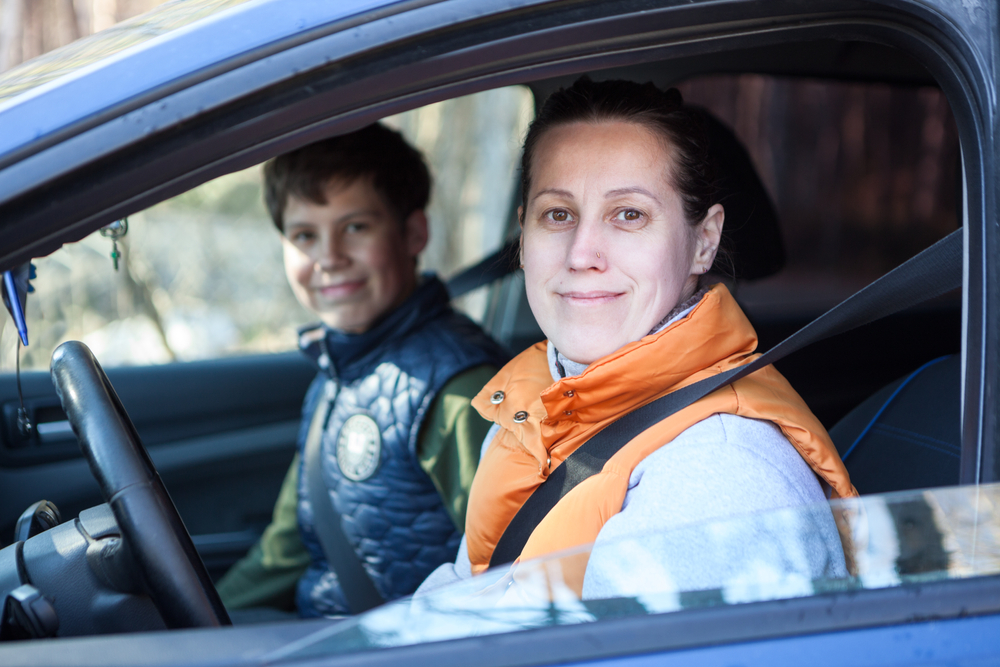 Mother and teen son in car going somewhere