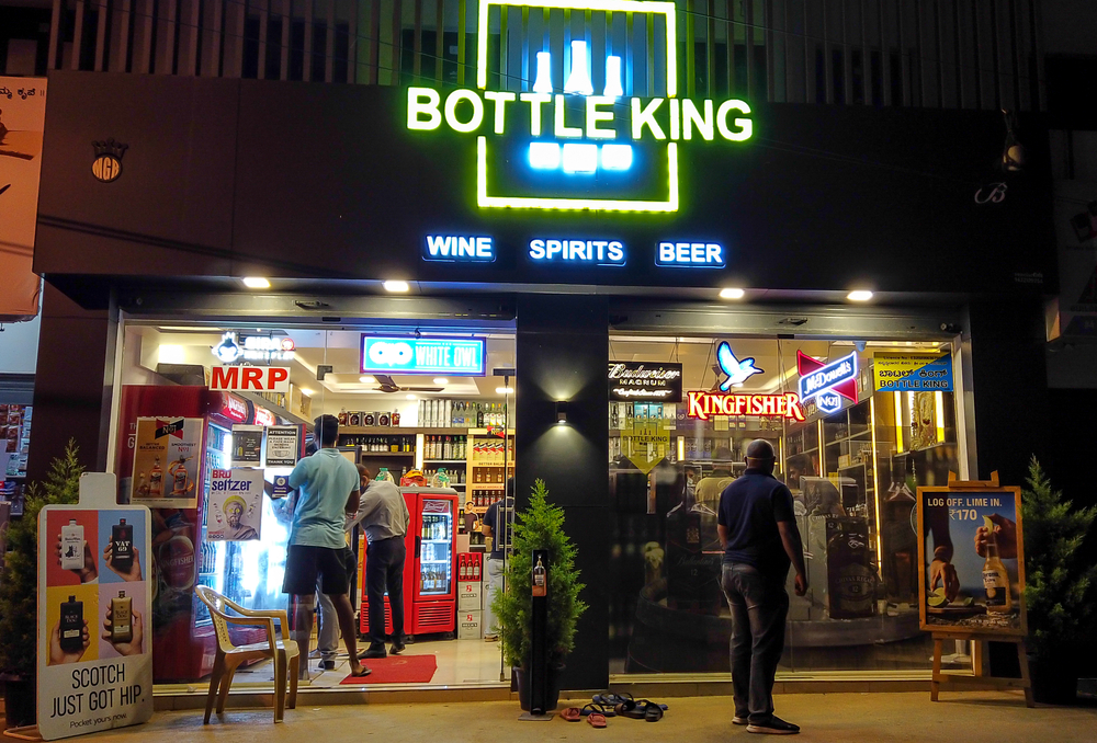 A Beautiful night view of a Liquor store illuminated with colorful neon Advertisement lights