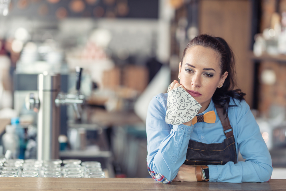 Sad woman at a bar after she had been fired