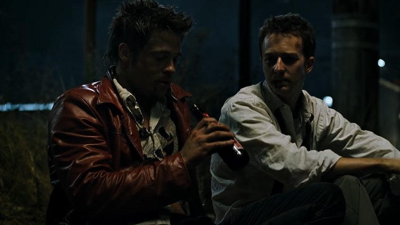 Brad Pitt and Edvard Norton in Fight Club sitting on a sidewalk