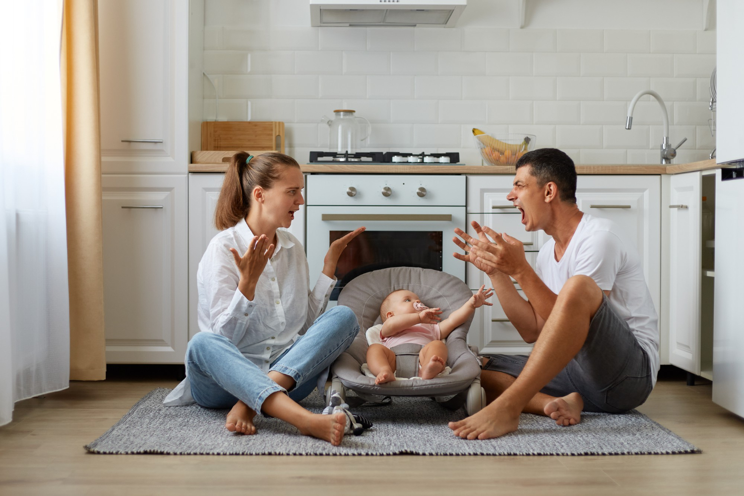 Woman is arguing with man and small baby standing between them on kitchen floor.