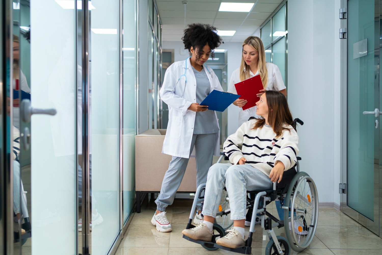 Young girl is talking with hospital personal in hallway.