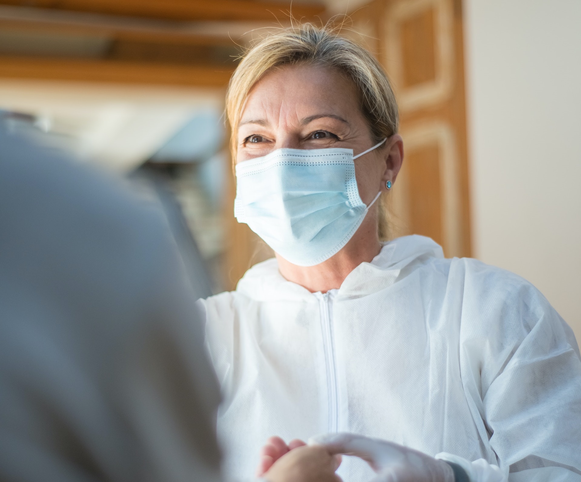 Female doctor is talking with a patient and smiling.