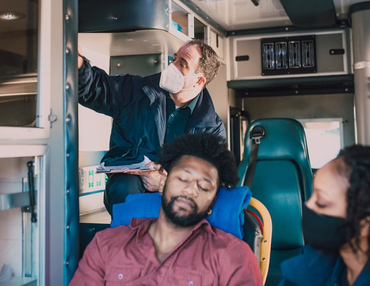 Sick black man is on the stretcher in hospital van.