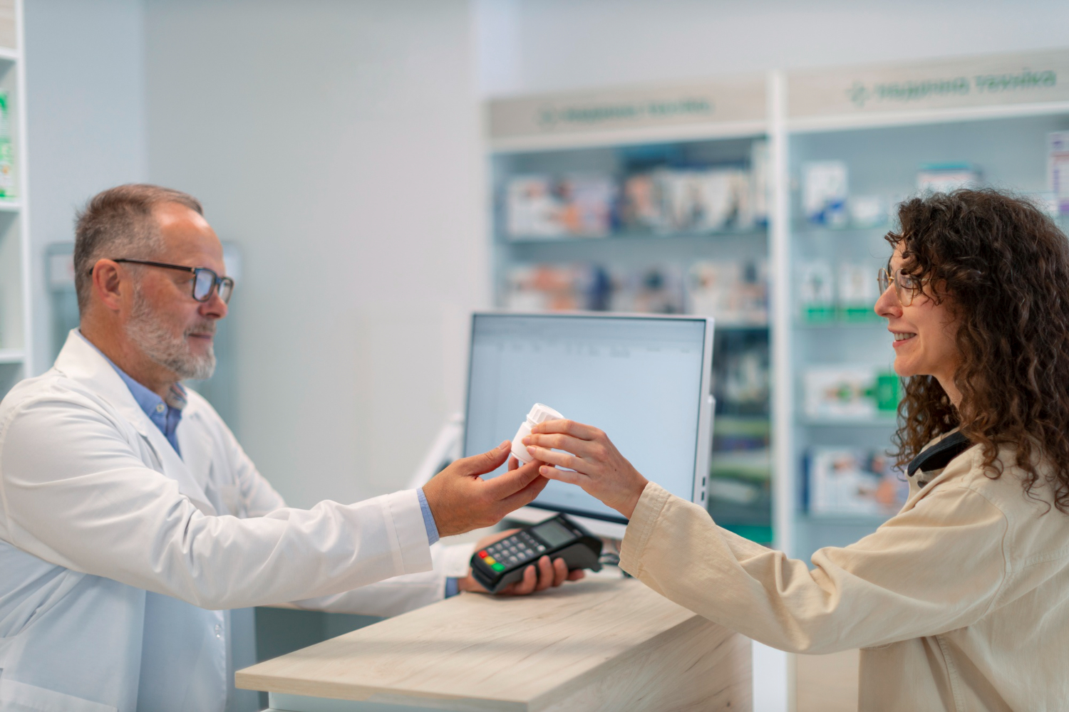 Woman is taking medication from a pharmacist.