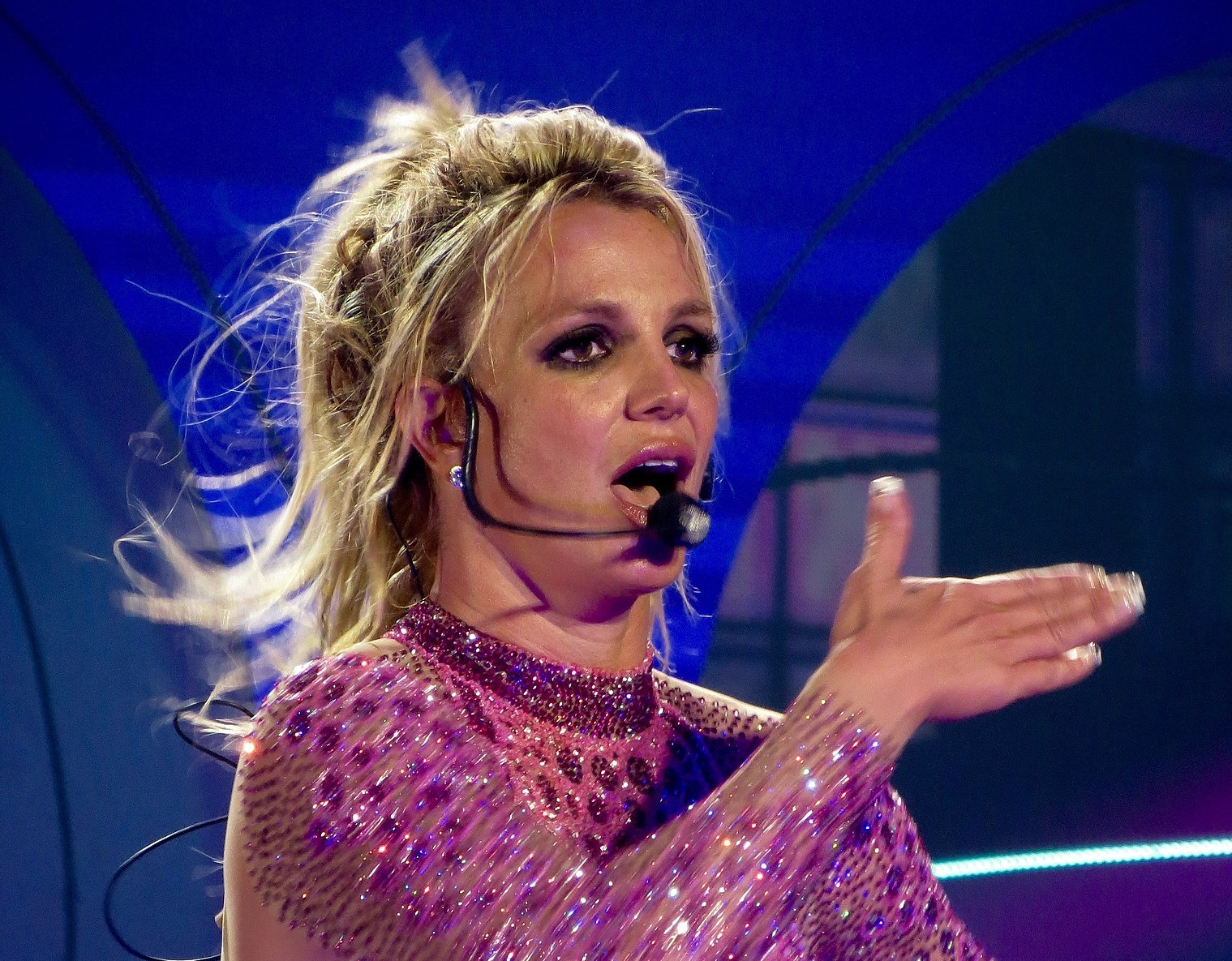 Britney Spears is singing on stage ,looking at side - 2016