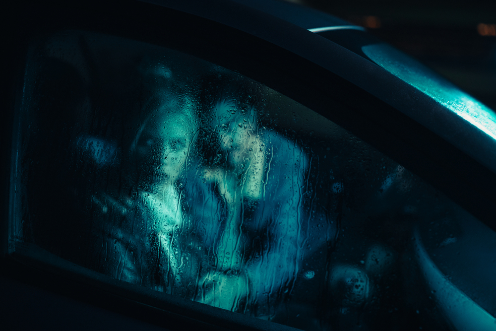 Scared couple in car at night
