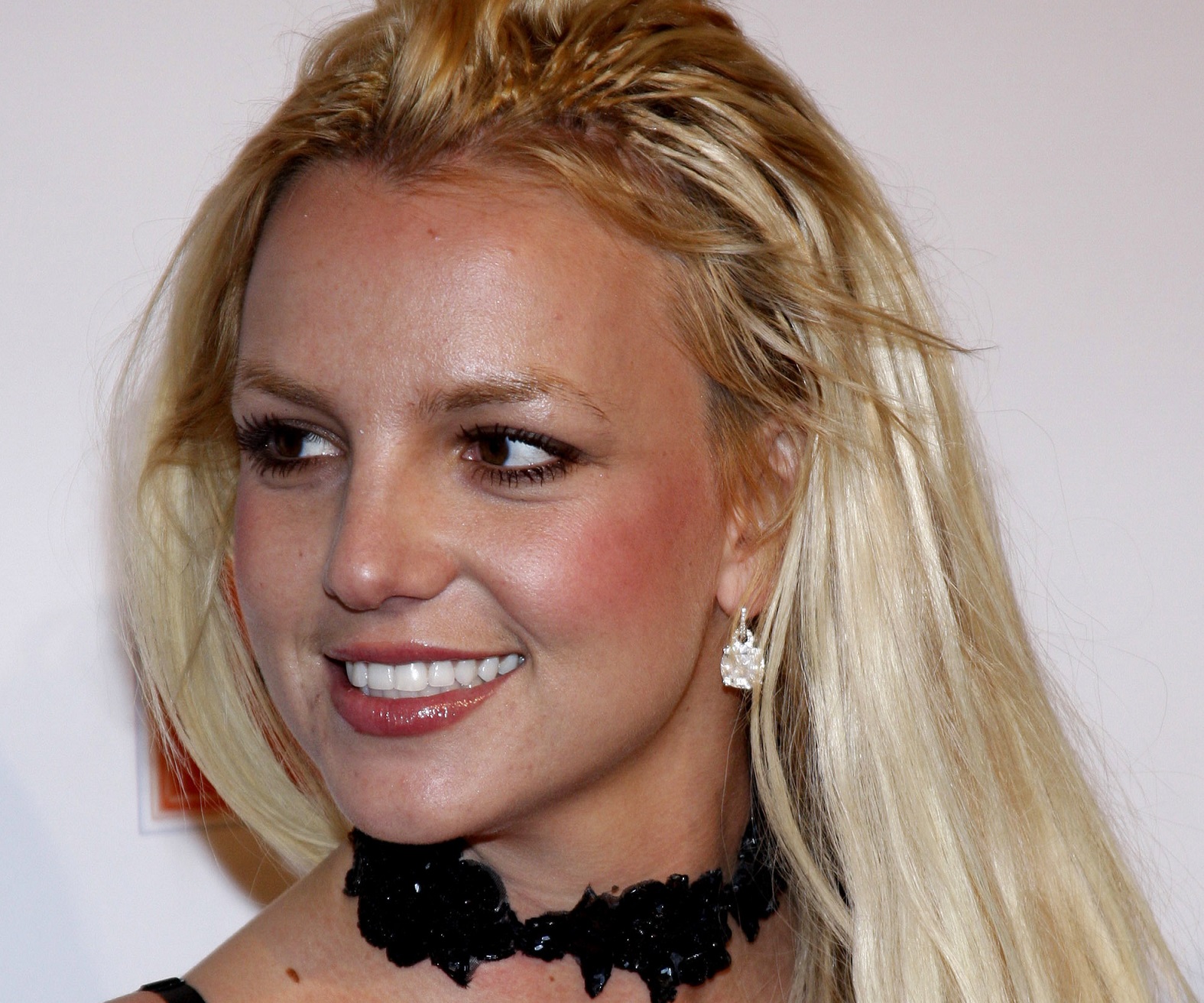 Britney Spears wearing black dress is smiling and looking at side - 2007