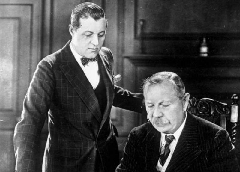 Conan Doyle with his son writing  something