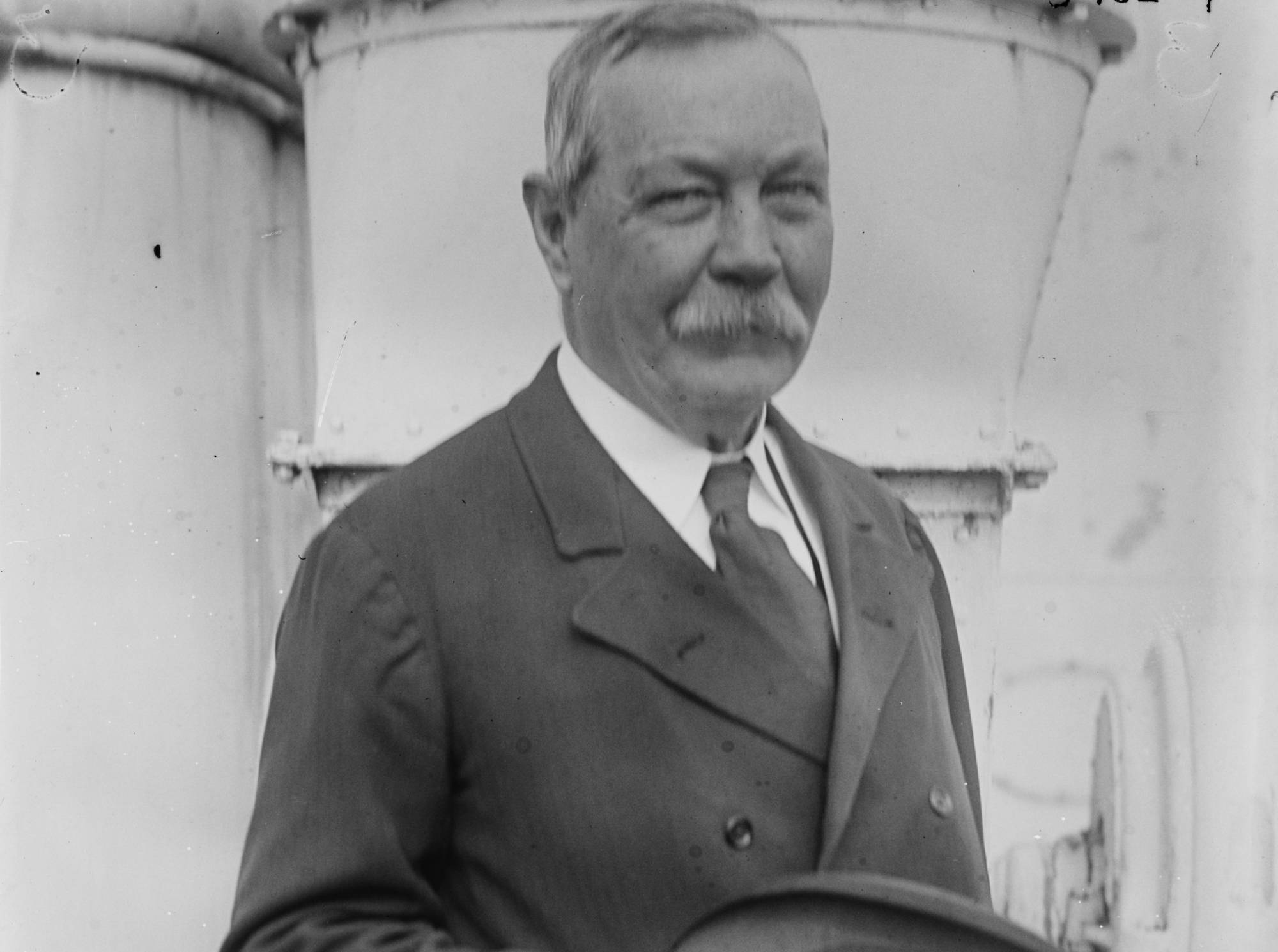 Arthur Conan Doyle on board a ship in suit