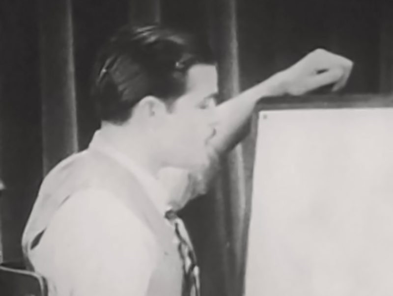 Rudolf Ising drawing on a board