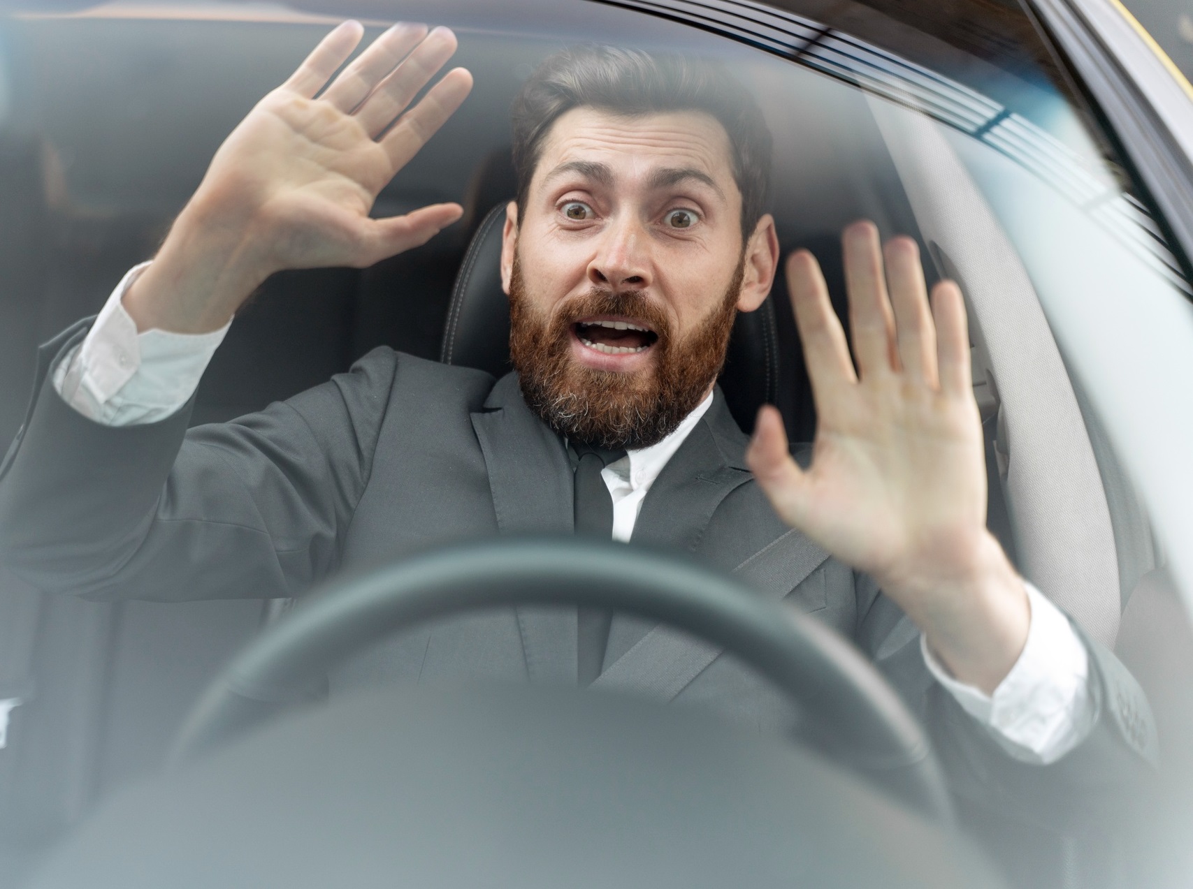Man is screaming inside a car.