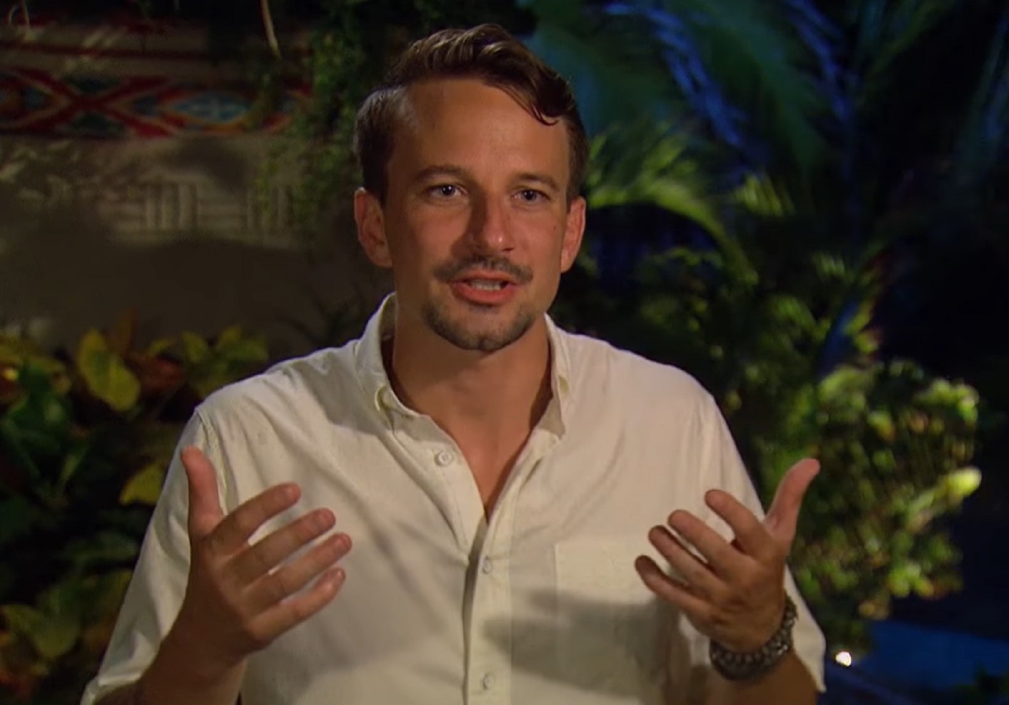 Screenshot: Evan Bass is looking at side with happy face - from Bachelor in Paradise (American TV series)