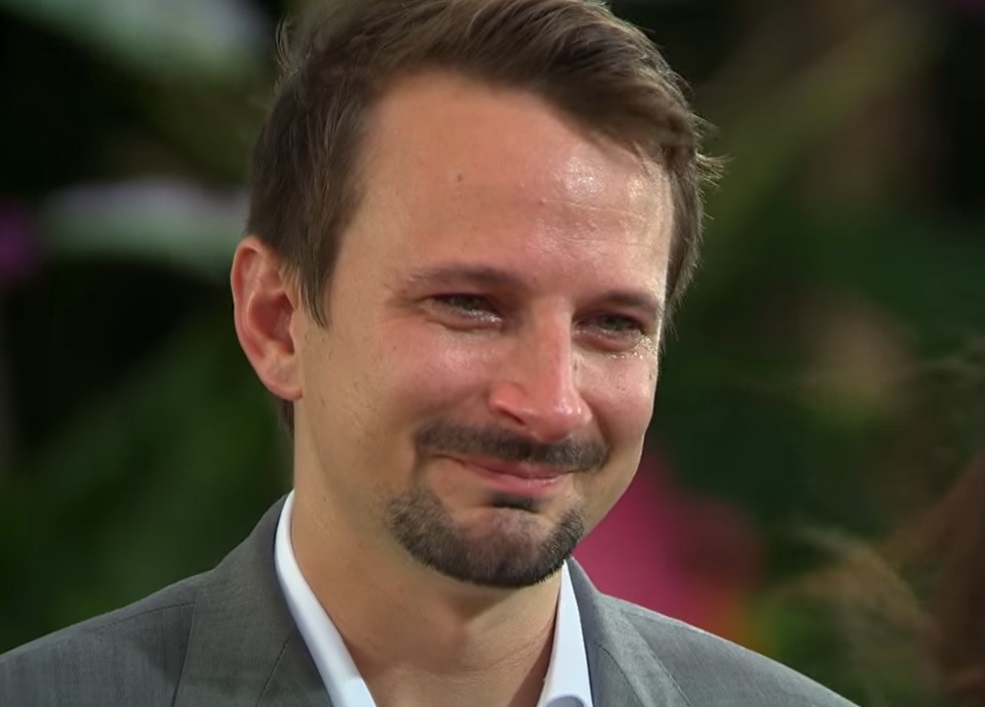 Screenshot: Evan Bass is looking at side with happy face - from Bachelor in Paradise (American TV series)