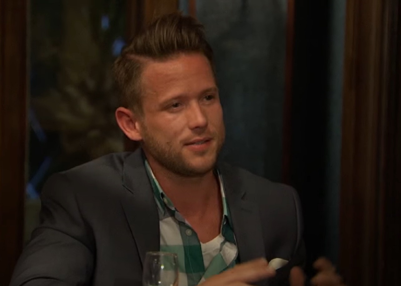Screenshot: Lee Garrett wearing grey jacket is looking at side - from The Bachelor (American TV series)