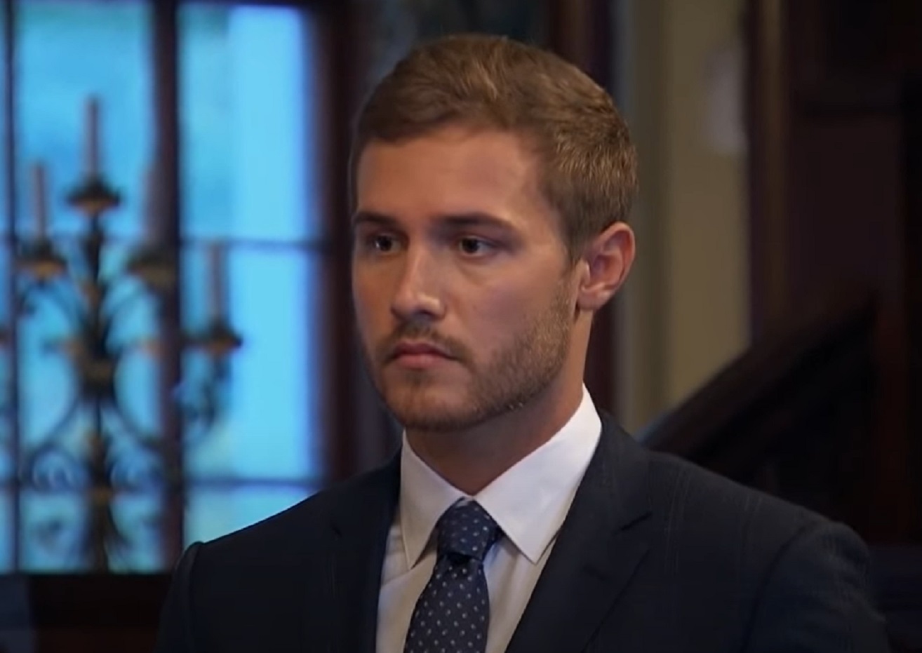 Screenshot: Peter Weber wearing black suit is looking at side  - from The Bachelor (American TV series)
