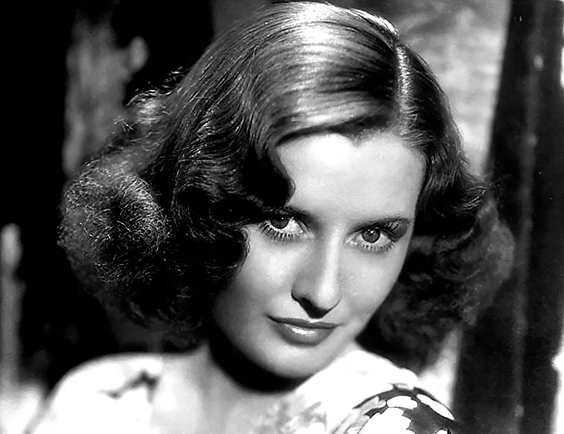 Signed publicity photo of Barbara Stanwyck in colorful top