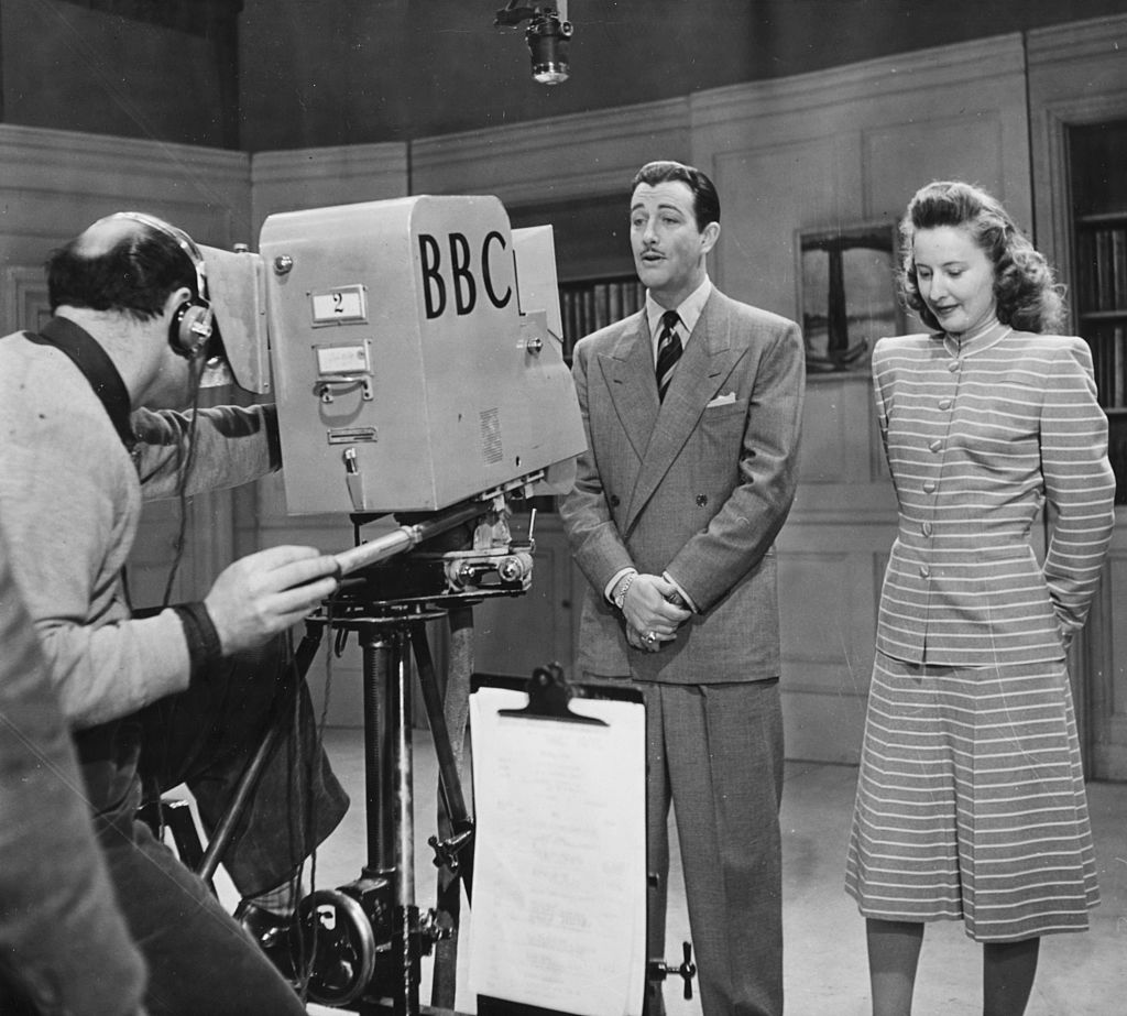 Actors Robert Taylor and Barbara Stanwyck in front of a BBC Television camera