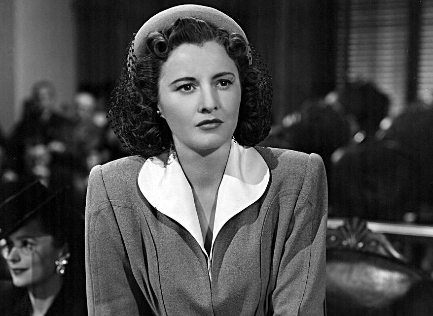 Studio publicity photo of Barbara Stanwyck for film The Gay Sisters in suit and hat