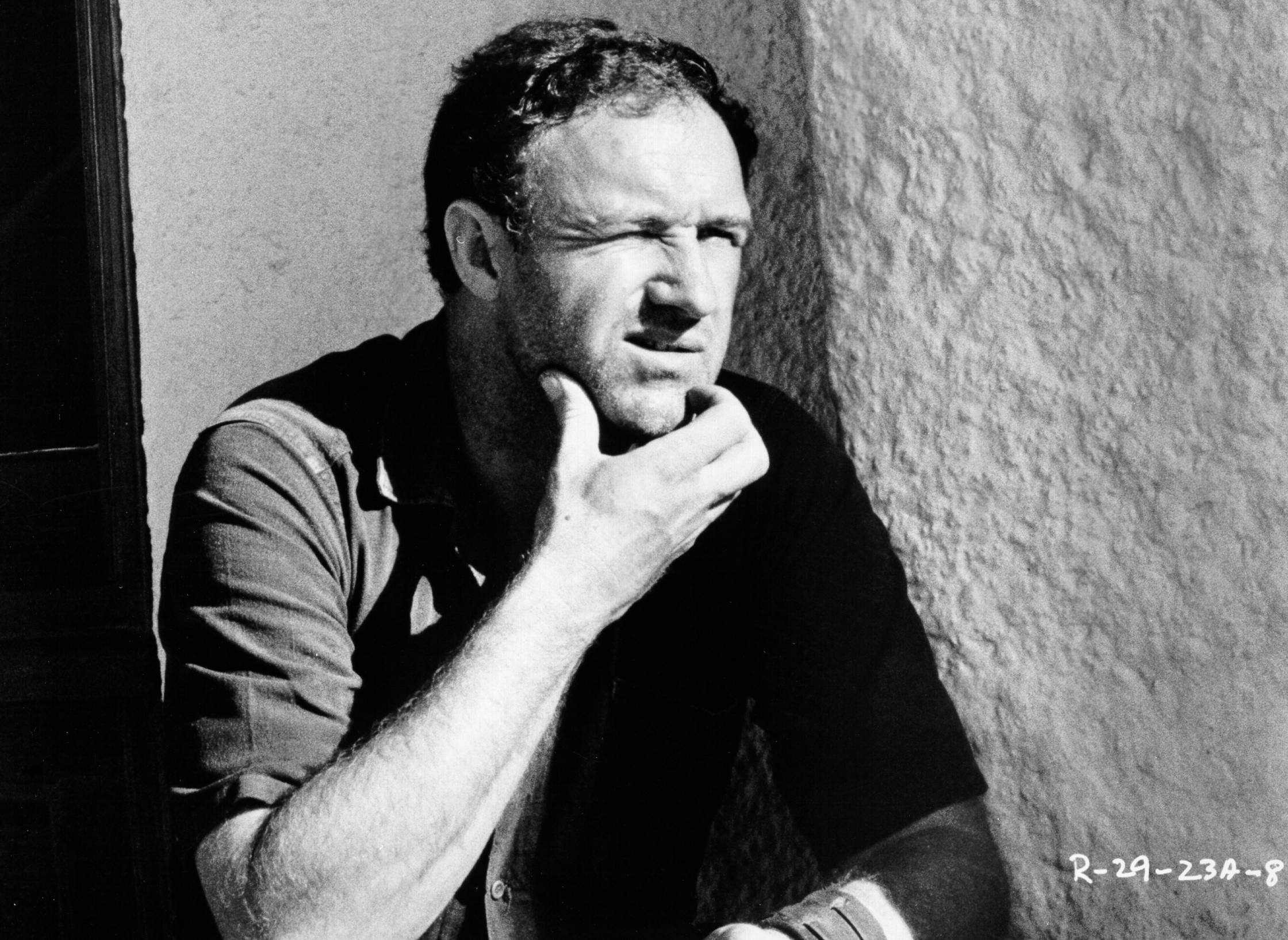 Photo of Gene Hackman Photo by Michael Ochs Archives sitting on stairs in shirt