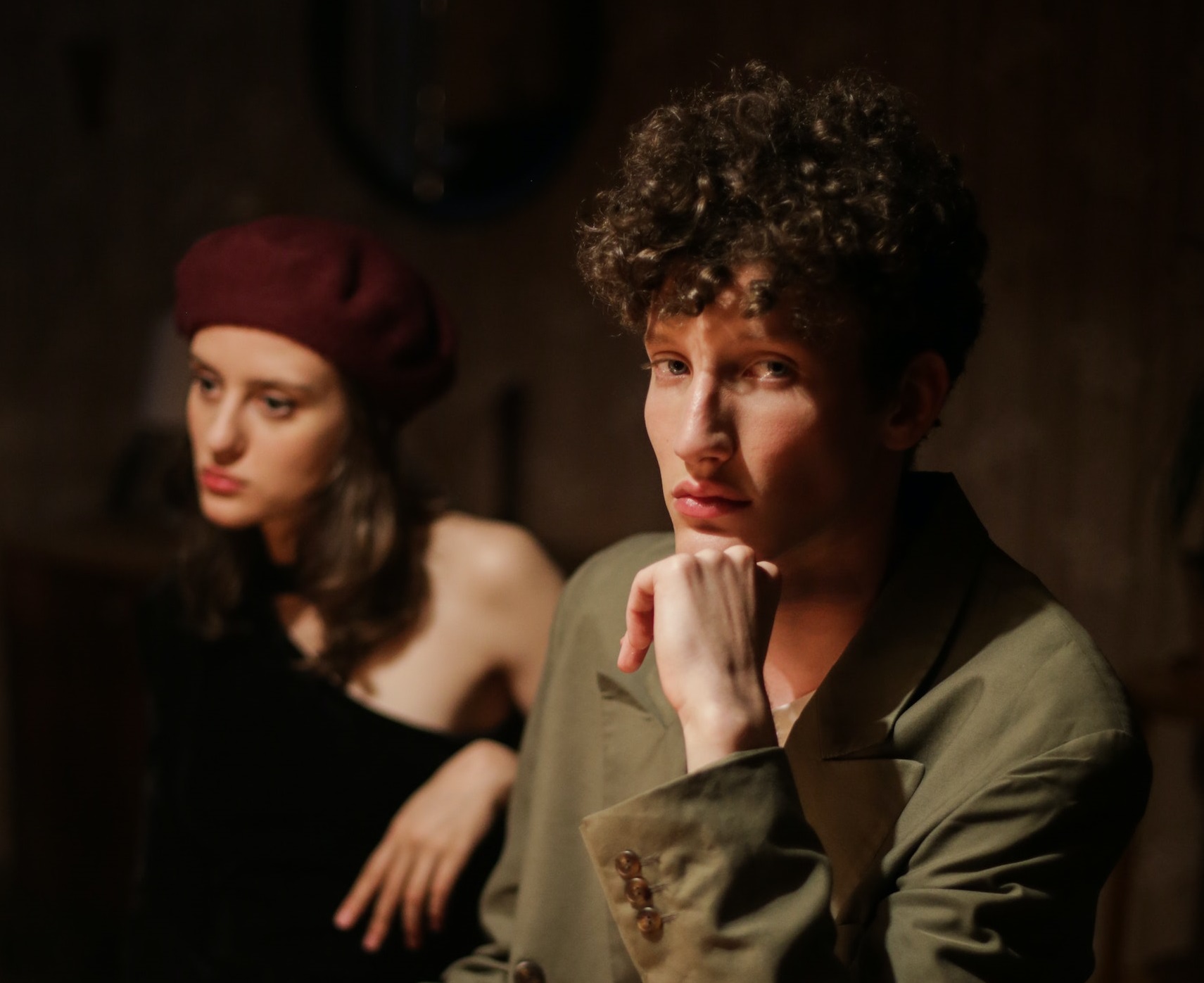 Man is looking sad ,seating next to a girl looking at side.