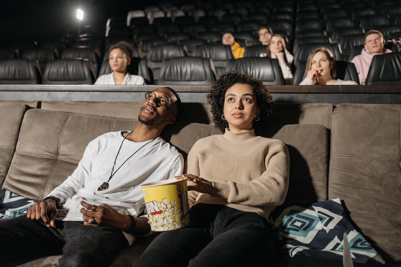 Couple is watching a movie at cinema.