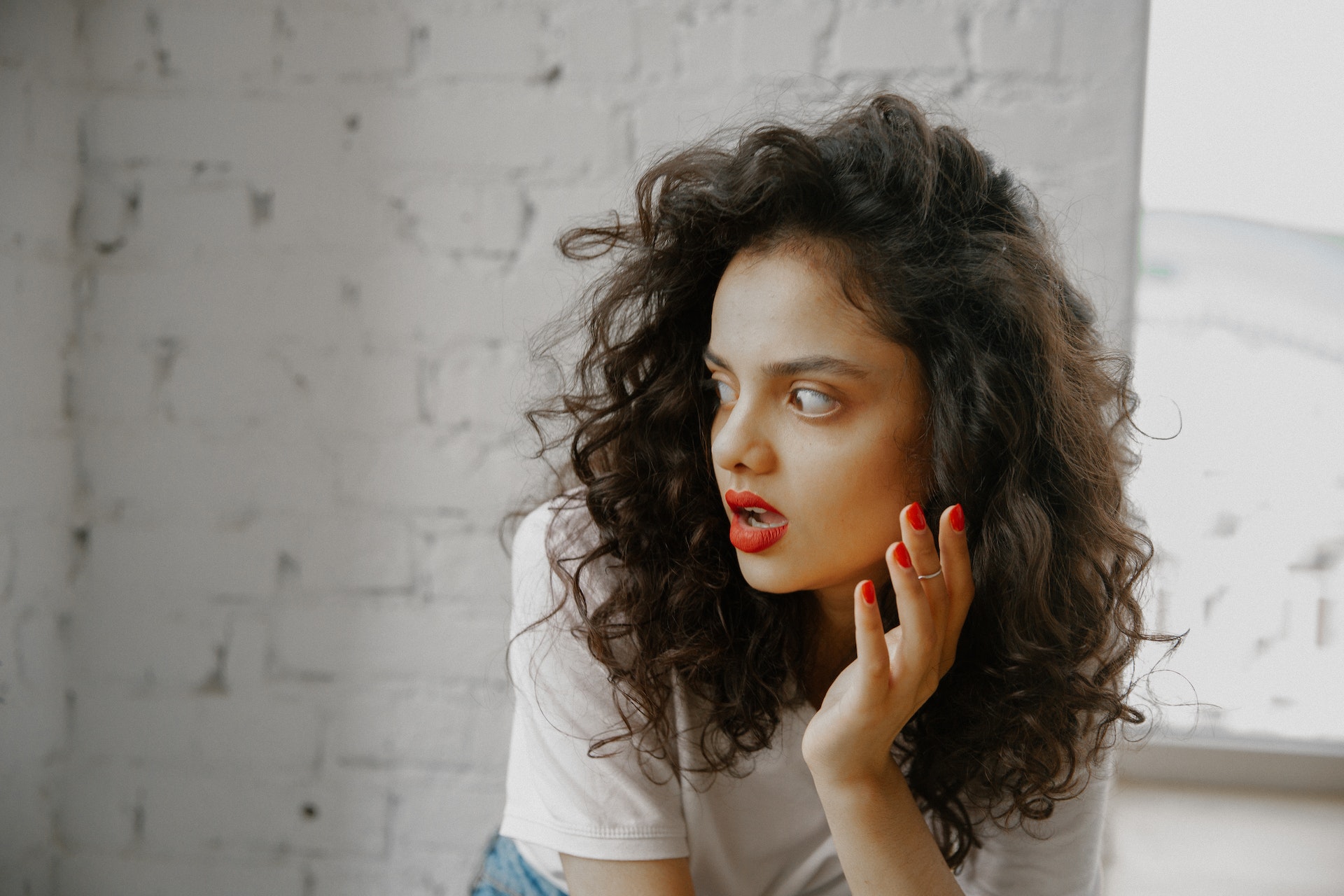 Young woman is looking at side with surprised face.